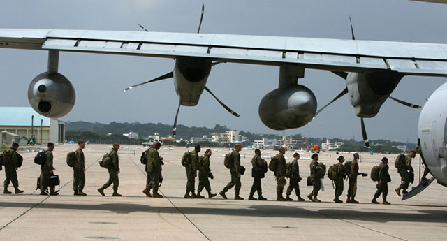 Marines boarding a KC-130J Super Hercules aircraft at Marine Corps Air Station Futenma in Okinawa.