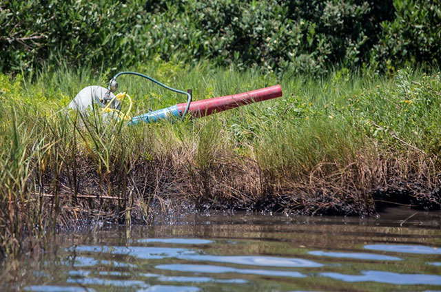 Noise machine in the marsh used to scare birds away from the oil spill. (Photo: Julie Dermansky)