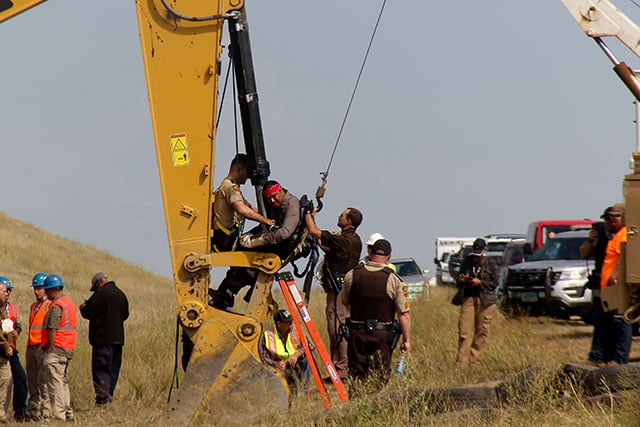 In one of the more dangerous attempts to remove American Horse, police attached a hydraulic crane to his body, putting him at serious risk of personal injury. Law enforcement also attempted to used a reciprocating saw to remove American Horse, which easily could have resulted in a severed limb, had the material of his blockade gear been breached. (Photo: Desiree Kane)