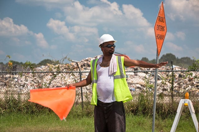 Naquille Everson directing traffic in front of the landfill on North Sherwood Forest Drive near Monticello, Louisiana. (Photo: Julie Dermansky)