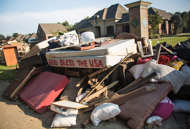 Belongings left outside flooded homes lined the streets of Walker, Louisiana, on September 2. (Photo: Julie Dermansky)
