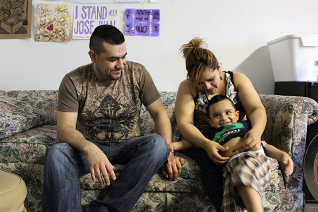 Jose Juan Moreno, his wife, and one of his sons sit together in the room at the University Church on Chicago's Southside where Moreno has sought sanctuary from ICE since April. (Photo: Hoda Katebi)