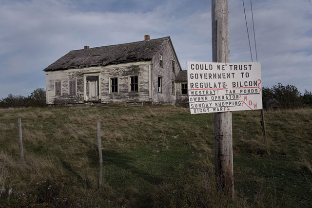 A protest sign sits in front of an abandoned home in rural Digby, Nova Scotia. During the five plus years that the environmental assessment was being conducted on the project, signs such as these, mostly against, but some in support of, Bilcon's plans, littered the otherwise quiet rural region. Today, some of these signs still stand, as the NAFTA Tribunal's award has yet to be finalized. (Photo by Russel Monk licensed under the Creative Commons Attribution-Share Alike 2.0 generic license)