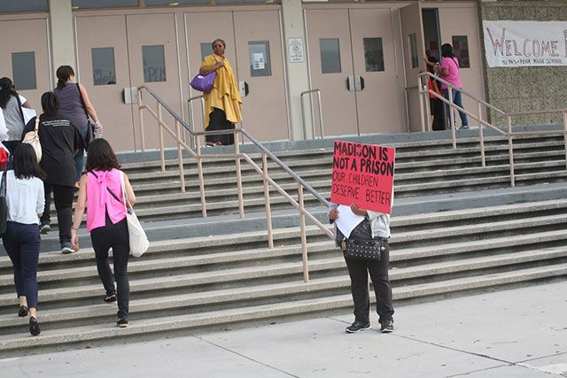 Protester at Pasadena High School for PUSD all-district meeting in February 2016. (Photo: Courtesy of CCEJAM)