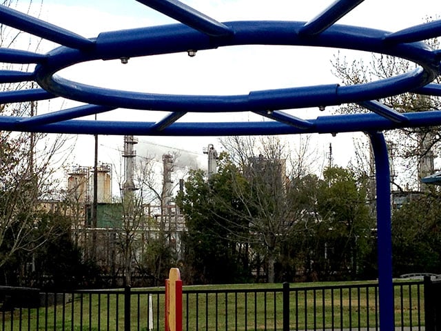 In this 2015 stock photo, emissions rise from a refinery behind the monkey bars at a playground in Norco, Louisiana. Residents and environmentalists have been sparring with the American Petroleum Institute over new EPA rules requiring operators to monitor for cancer-causing benzene emissions where refineries share fence lines with residential areas. The industry supports politicians that oppose to such regulations. (Photo: Mike Ludwig)