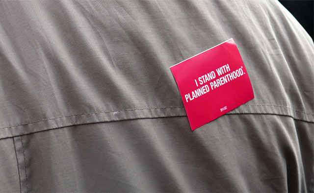 A demonstrator wears a sticker in support of Planned Parenthood at a rally in New York City on February 26, 2011. (Photo: Charlotte Cooper)