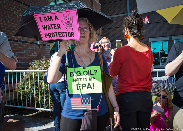 An activist identifying as a water protector, as inspired by the Standing Rock Sioux Tribe against the Dakota Access pipeline, stands outside Sen. Cassidy's town hall in Metairie, Louisiana. (Photo: Julie Dermansky)