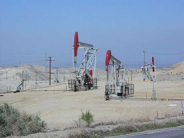 Three active oil wells (in foreground), Elk Hills Oil Field, off of Elk Hills Road south of Buttonwillow, California.