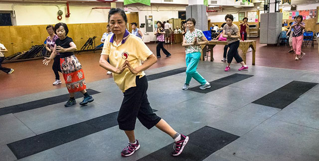Seniors at Queens Community House practice tai chi. (Photo Courtesy: Queens Community House)