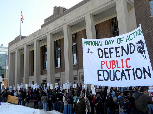 Demonstrators display signs at the National Day of Public Education demonstration against rising tuition costs at the Univeersity of Minnesota, in Minneapolis, Minnesota, March 24, 2014. (Photo: Fibonacci Blue)