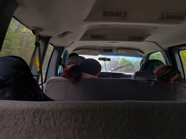 After their visit on May 13, passengers sleep in the van back to New York City from Altona. The ride back is expected to take up to 8 hours. (Photo: Ese Olumhense)