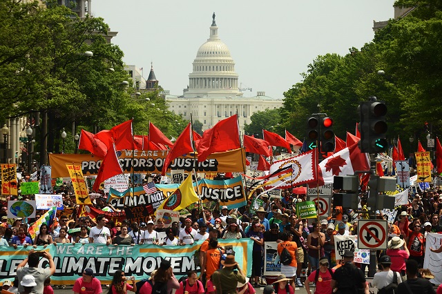 People march from the U.S. Capitol to the White House for the People's Climate Movement to protest President Donald Trump's enviromental policies April 29, 2017 in Washington, DC. Demonstrators across the country are gathering to demand a clean energy economy. (Photo: Astrid Riecken / Getty Images)