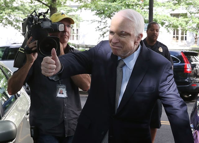 Sen. John McCain gives a thumbs up to well wishers as he gets into his car at the US Capitol July 25, 2017 in Washington, DC. McCain was recently diagnosed with brain cancer but returned on the day the Senate is holding a key procedural vote on U.S. President Donald Trump's effort to repeal and replace the Affordable Care Act. (Photo: Mark Wilson / Getty Images)