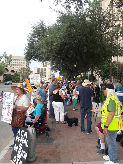 Demonstrators rally outside of Senator John McCain's Tucson office on July 26, 2017. (Photo courtesy of Lauren Klinkhammer)