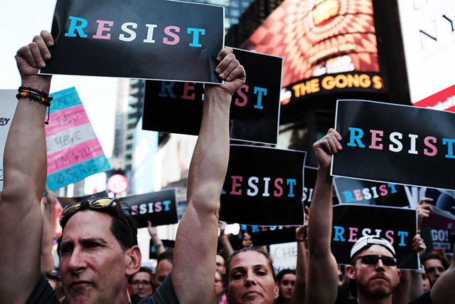 Dozens of protesters gather in Times Square near a military recruitment center to show their anger at President Donald Trump's decision to reinstate a ban on transgender individuals from serving in the military on July 26, 2017 in New York City. (Photo: Spencer Platt / Getty Images)