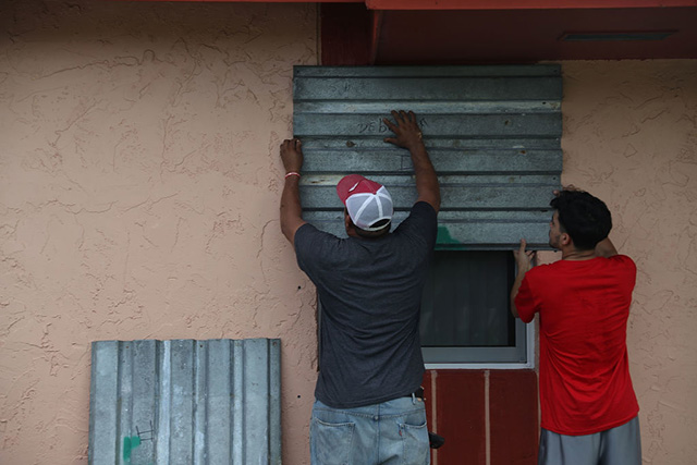 Jose Escobar and his son, Jose Escobar, Jr. put up shutters as they prepare for Hurricane Irma on September 5, 2017 in Homestead, Florida. A state of emergency has been declared in Florida as Irma has intensified to a Category 5 hurricane and heads toward the region. (Photo:  Joe Raedle / Getty Images)
