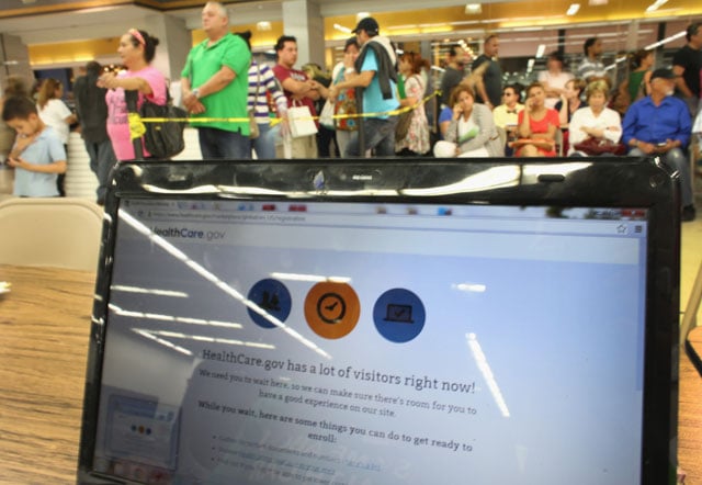 People wait in line to see an agent from Sunshine Life and Health Advisors as the Affordable Care Act website is reading, 'HealthCare.gov has a lot of visitors right now!' at a store setup in the Mall of Americas on March 31, 2014 in Miami, Florida. (Photo: Joe Raedle / Getty Images)