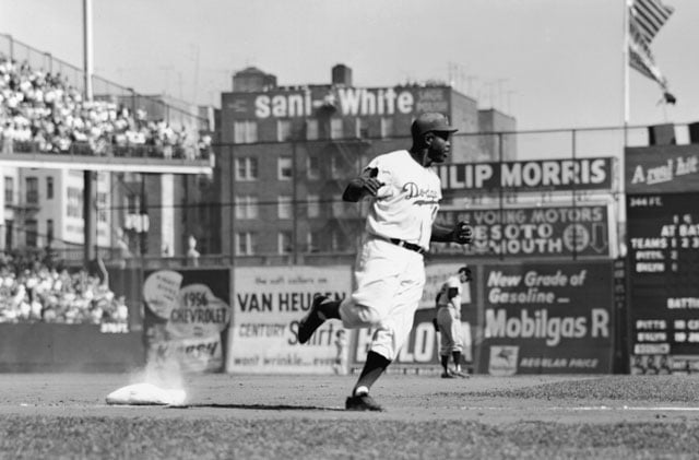 American baseball player Jackie Robinson (1919 - 1972) of the Brooklyn Dodgers rounds third base during a home game at Ebbets Field, New York, New York, 1950s. (Photo: Robert Riger / Getty Images)