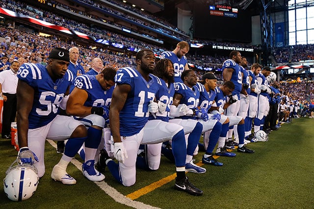 Members of the Indianapolis Colts stand and kneel for the national anthem prior to the start of the game between the Indianapolis Colts and the Cleveland Browns at Lucas Oil Stadium on September 24, 2017 in Indianapolis, Indiana. (Photo: Michael Reaves / Getty Images)