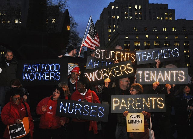 Protesters demonstrate for a $15 minimum wage and better benefits and working conditions in New York City, December 5, 2013.