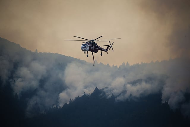 Tanker helicopters fight a wildfire on October 16, 2017, in Oakville, California. At least 42 people were killed and many are still missing. At least 8,400 buildings have been destroyed. (Photo: Elijah Nouvelage / Getty Images)