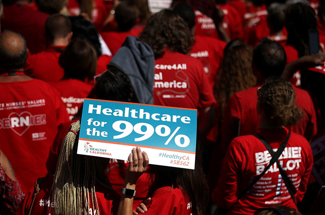 Supporters hold signs as Sen. Bernie Sanders speaks about his Medicare for All Act during a health care rally at the 2017 Convention of the California Nurses Association/National Nurses Organizing Committee on September 22, 2017, in San Francisco, California. (Photo: Justin Sullivan / Getty Images)