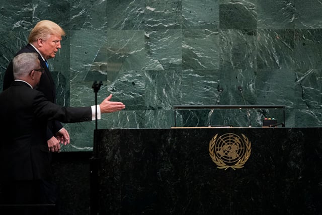 Donald Trump is escorted by a protocol official as he prepares to take the lectern to address the United Nations General Assembly at UN headquarters, September 19, 2017, in New York City. (Photo: Drew Angerer / Getty Images)