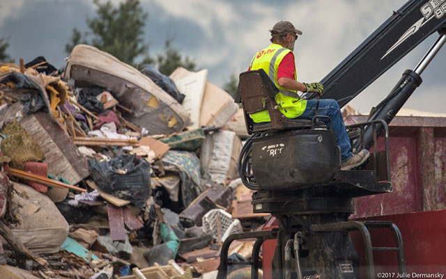 A worker, not wearing protective gear, at the temporary dumpsite on 19th Street in Port Arthur, Texas. (Photo: Julie Dermansky)