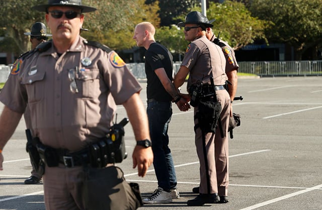 White nationalist Tyler Tenbrink of Houston, Texas, is handcuffed by Florida Highway Patrol troopers at a speech by white supremacist Richard Spencer at the University of Florida campus on October 19, 2017, in Gainesville, Florida. Tenbrink was later arrested, along with friends William Fears and Colton Fears, as suspects in a shooting following the speech. (Photo: Brian Blanco/Getty Images)