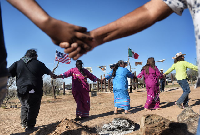 Indigenous people from the Tohono O'odham ethnic group dance and sing to protest against US President Donald Trump's intention to build a new wall in the border between Mexico and United States, on March 25, 2017, in the Altar desert, in Sonora, in the border with Arizona, northern Mexico. (Photo: Pedro Pardo / AFP / Getty Images)