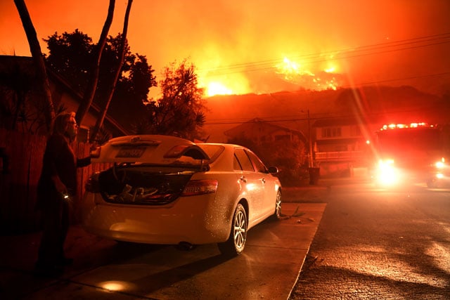A resident packs her car as the Thomas Fire approaches the town of La Conchita early on December 7, 2017. A new study suggests that the planet is far likelier to become four degrees Celsius warmer by 2100 than previously thought. (Photo: Wally Skalij / Los Angeles Times via Getty Images)