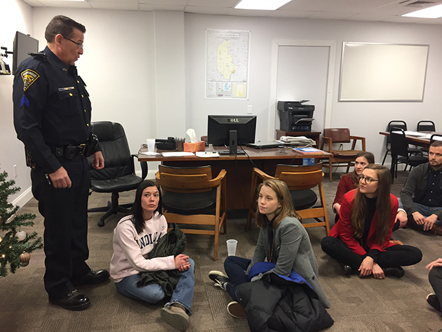 Risking arrest, activists from Campus Action for Democracy occupy the office of US Rep. Trey Hollingsworth (R-Indiana) on December 11, 2017. The activists are graduate students at Indiana University and they staged a sit-in to pressure their representative to vote against the tax bill. (Photo: Denisa Jashari)