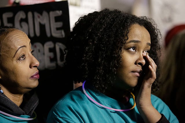 Megitu Argo (L) and her daughter Ebany Turn cry as a family of Somali refugees speaks to the audience about their cousin's deportation back to Somalia at a rally for immigrants and refugees in Seattle, Washington, on January 29, 2017. (Photo: JASON REDMOND / AFP / Getty Images)