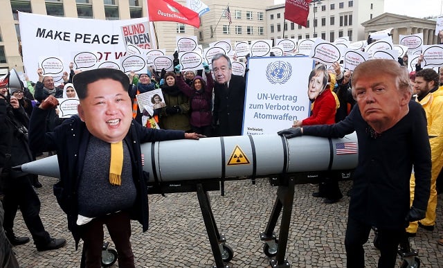  An activist with a mask of Kim Jong-un, chairman of the Workers' Party of Korea and supreme leader of North Korea (L), and another with a mask of U.S. President Donald Trump, march with a model of a nuclear rocket during a demonstration against nuclear weapons on November 18, 2017 in Berlin, Germany. About 700 demonstrators protested against the current escalation of threat of nuclear attack between the United States of America and North Korea. The event was organized by peace advocacy organizations including the International Campaign to Abolish Nuclear Weapons (ICAN), which won the Nobel Prize for Peace this year. (Photo by Adam Berry/Getty Images)