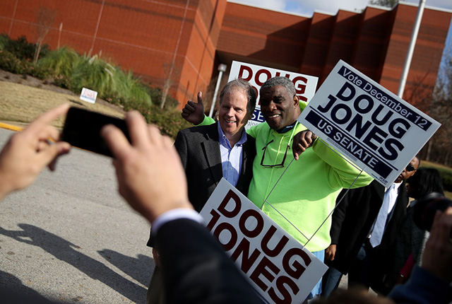 Democratic senatorial candidate Doug Jones takes a picture with voters outside of a polling station at the Bessemer Civic Center on December 12, 2017 in Bessemer, Alabama. (Photo: Justin Sullivan / Getty Images)
