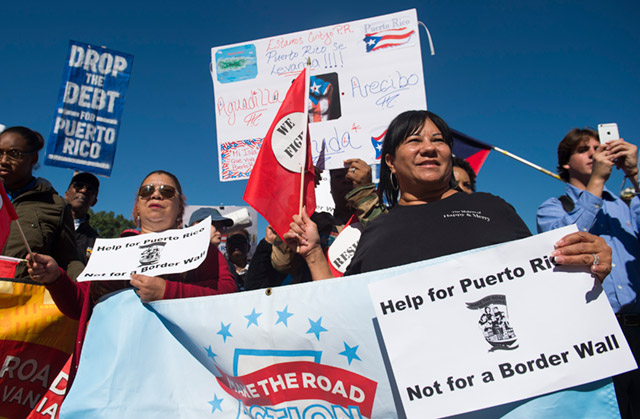Demonstrators hold a protest to demand more recovery assistance for areas hit by recent hurricanes, including Puerto Rico from Hurricane Maria, during the 'March for Just Recovery,' on Capitol Hill in Washington, DC, on October 18, 2017. (Photo: Saul Loeb / AFP / Getty Images)