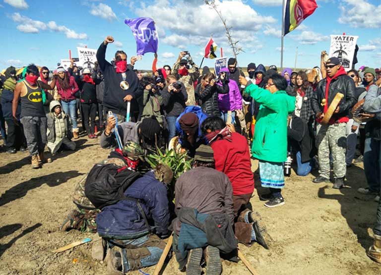 Water protectors planting cedar trees in the path of the Dakota Access pipeline in September 2016. Mounting an effective resistance opposition against pipeline projects in remote areas requires that activists be able to operate – and stay connected to the web. To Henry Red Cloud, off-grid solar is the ideal technology to meet that need. (Photo: Saul Elbein)