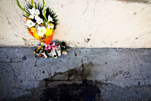 A photo of José Antonio left on the US side of the border wall by protesters Nov. 2, 2012. The photo and candles are near where José's killer would have been standing. (Photo: Murphy Joseph Woodhouse)