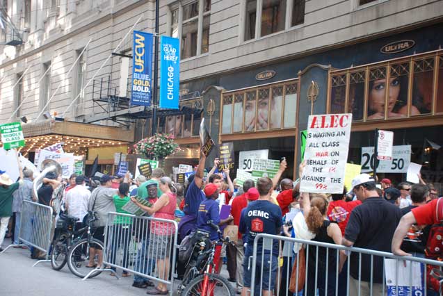Protestors pack the sidewalk all along Monroe Street outside the Palmer House Hotel in Chicago where the American Legislative Exchange Council (ALEC) met for their 40th anniversary conference. (Photo: James Anderson)