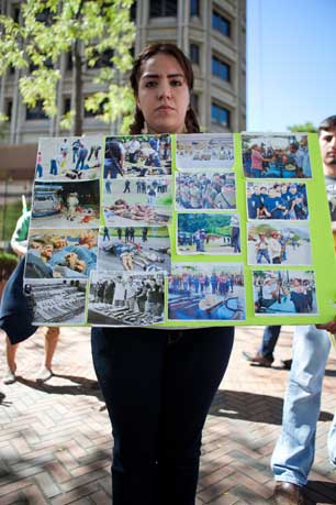 Ruby, Grisel's sister, holds a collage of photos showing the violence in Guerrero.