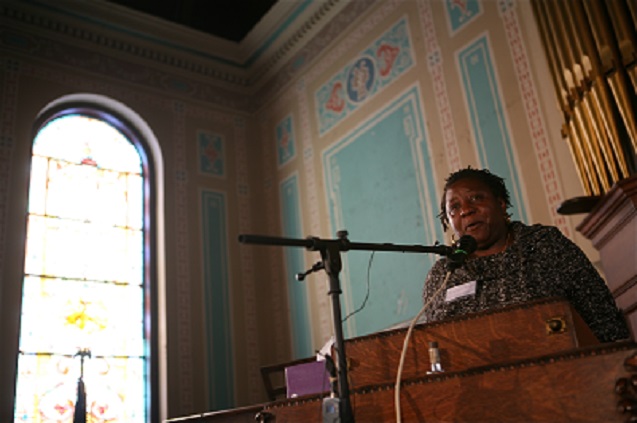 A witness presents testimony at the World Court of Women on Poverty. (Photo: Harvey Finkle).