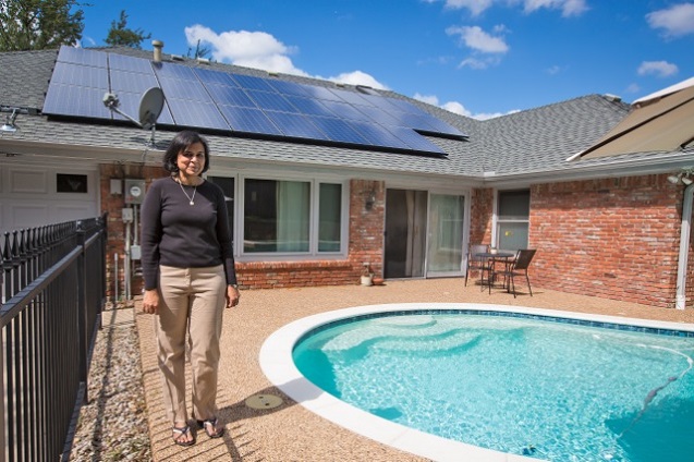 Ranjana Bhandari in front of solar panels on her home in Arlington, Texas. (Photo: ©2013 Julie Dermansky)