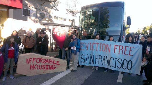 Community activists and residents of the Mission hold a rally in front of a blockaded bus, originally bound for Apple's Headquarters in Cupertino. (Photo: Christopher Longenecker)