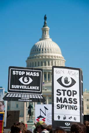 Protesters rally against mass surveillance during an event organized by the group Stop Watching Us in Washington, DC on October 26, 2013.
