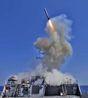 The USS Barry launches a Tomahawk cruise missile from the ships bow.