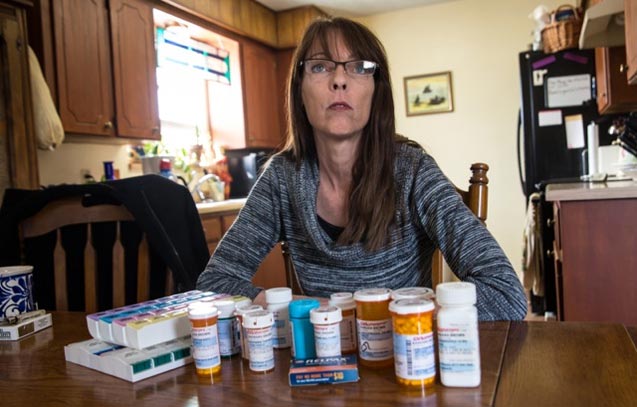 Barbara Brown with medications she takes for health problems developed after franking intensified near her Reno, Texas home. She lives less than a mile from a franking site and a wastewater disposal site. Her home has been damaged by an earthquake swarm that started rattling the ground in November, 2013, shortly after the disposal plant began operation. (Photo: ©2014 Julie Dermansky)