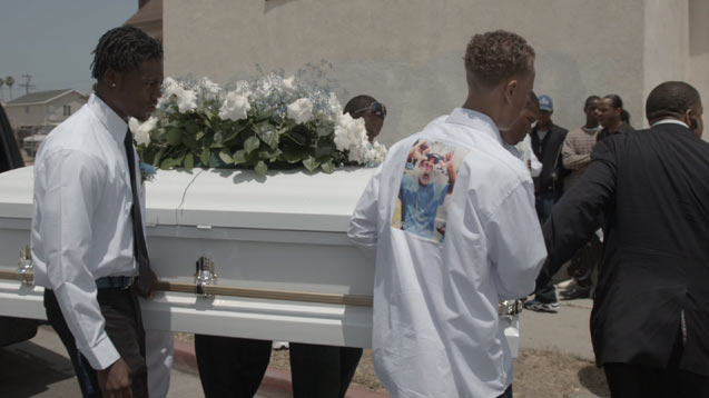 Community members carry the casket of JoJo, a young man killed by a rival gang. (Photo: License to Operate)