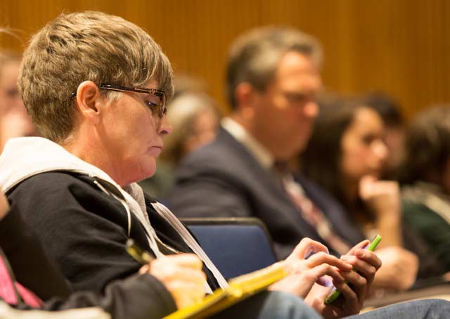 Sharon Wilson, Texas representative for the environmental group Earthworks live tweeting from a council meeting earlier this year. (Photo: ©2014 Juile Dermansky)