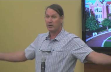 Dr. Andy Opel (FSU Faculty) is giving public comment, decrying corporate influence in the search and calling for a restructuring. He was later escorted out by the police for disruptions after Sen. John Thrasher was allowed to continue as a candidate. (Photo: Ralph Wilson, from the livestream of the meeting)