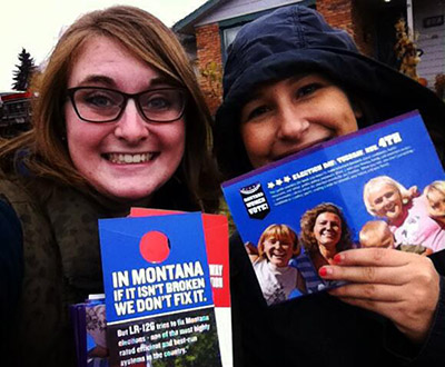 Micah Nielsen and Lily Boshier of Montana Women Vote canvass in the rain to stop LR-126 to protect Election Day registration on Monday, Nov. 3rd. (Photo: Micah Nielsen)